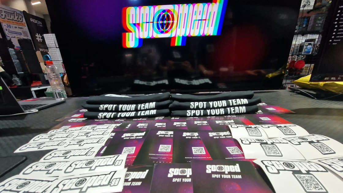 Scoped shirts, stickers and flyers on our EPICENTER 2026 stand, with the Scoped logo on the screen behind
